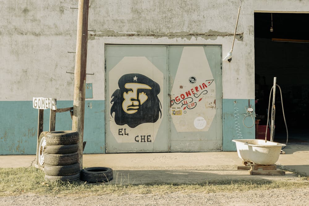 Documentary photography of a rural workshop facade with a Che Guevara mural in Argentina, by visual artist Irene Pietrella